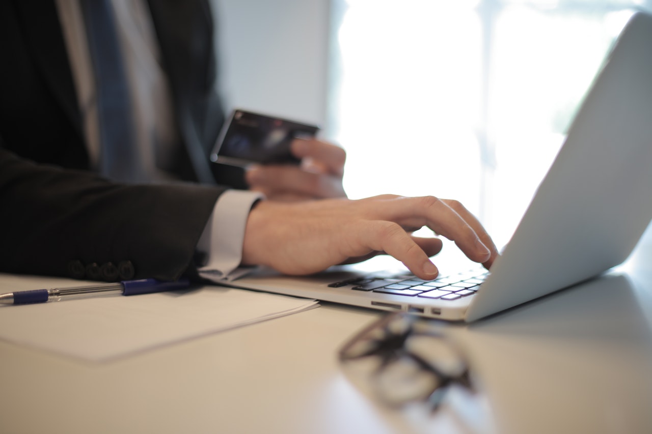 person-in-black-suit-typing-on-a-computer